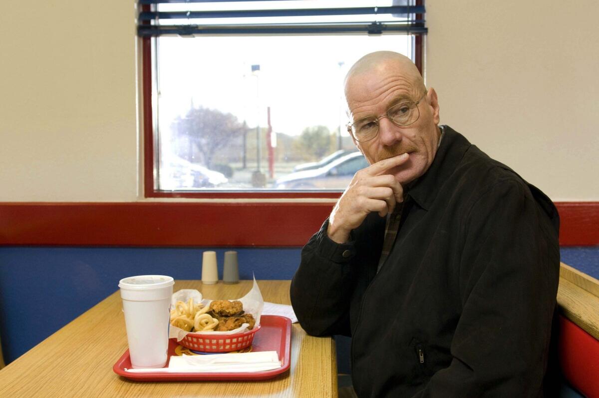 Walter White, played by Bryan Cranston, is seen at the fictional restaurant Pollos Hermanos in Season 2 of "Breaking Bad." The fast-food outlet used as the set displays posters boasting, "'Breaking Bad' was filmed here."