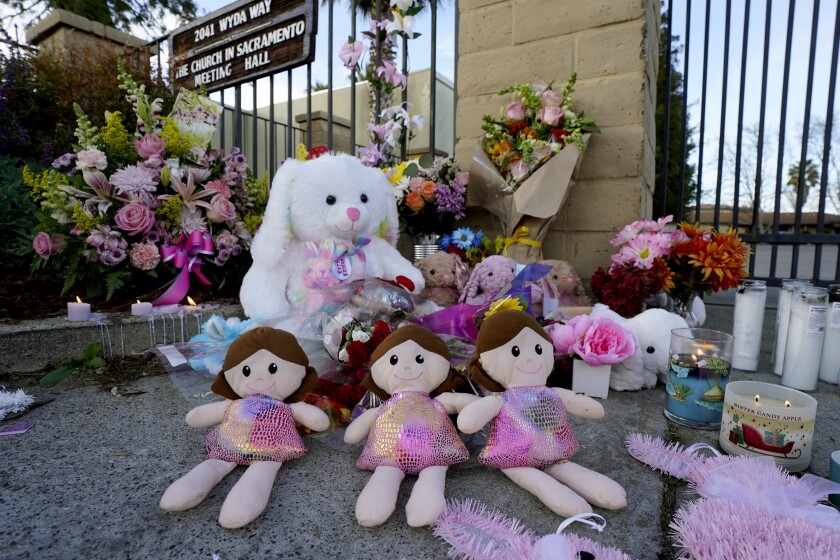 A memorial for the three young girls, who were slain by their father at The Church in Sacramento, is seen outside the church in Sacramento Calif., Tuesday, March 1, 2022. David Mora, who was under a restraining order and not supposed to have a gun, fatally shot his three daughters, a chaperone and himself Monday during a supervised visit with the girls. (AP Photo/Rich Pedroncelli)
