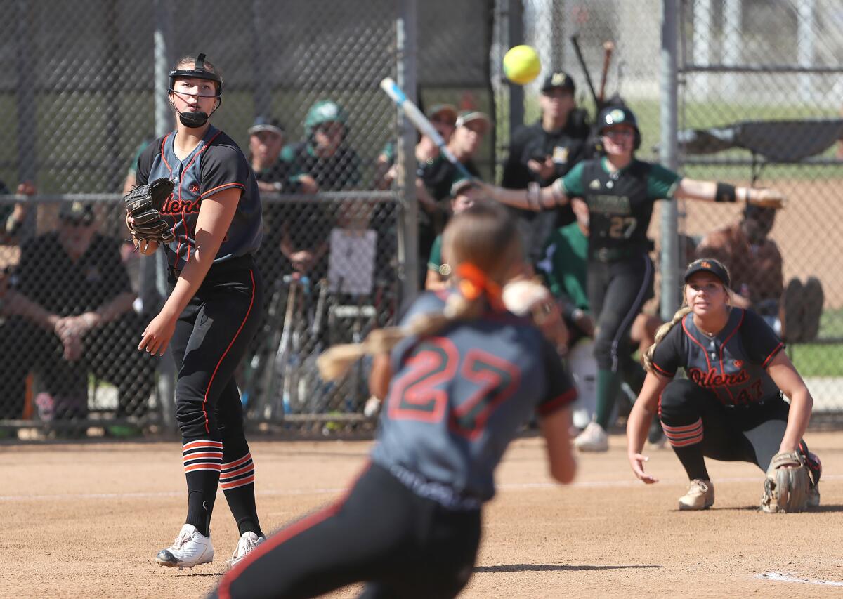 Huntington Beach pitcher Zoe Prystajko (44), far left, makes a throw to Macy Fuller (27) for an out against Murrieta Mesa.