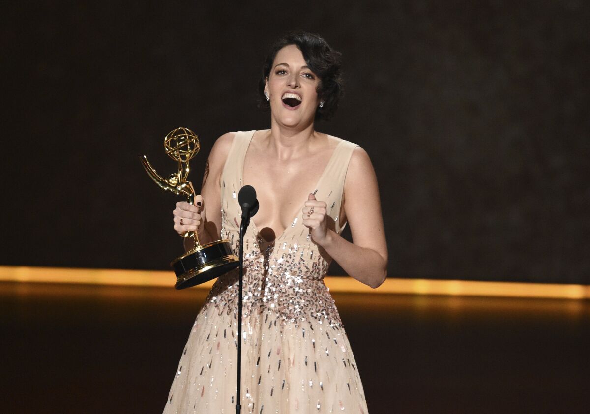 Phoebe Waller-Bridge accepts the award for writing for a comedy series for "Fleabag" at Sunday's Emmy Awards. Now she has a deal with Amazon. 
