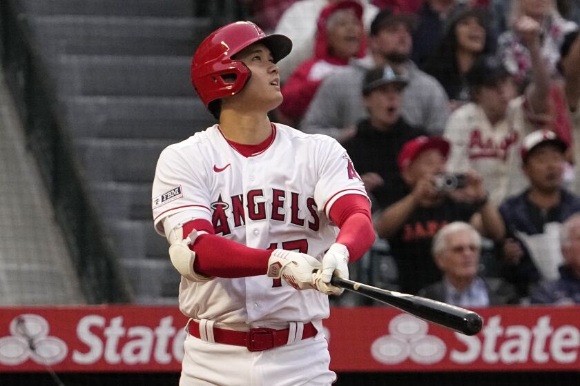 Los Angeles Angels' Shohei Ohtani follows through as he hits a two-run home run.