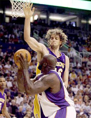 Phoenix center Shaquille O'Neal fakes Lakers center Pau Gasol into the air on a play in the first half Sunday afternoon.