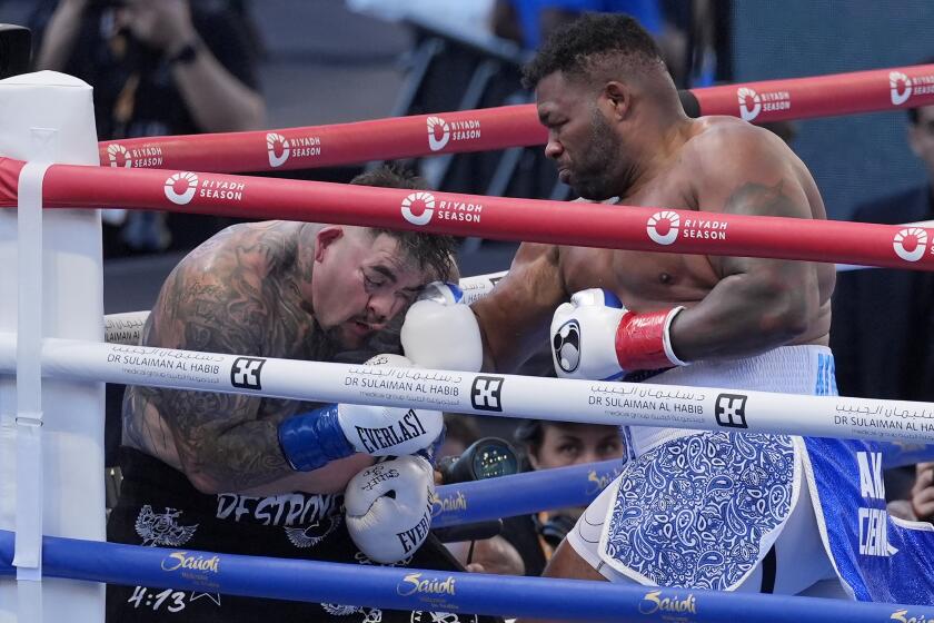 Jarrell Miller, right, punches Andy Andy Ruiz Jr., left, during a heavyweight boxing match in Los Angeles, Saturday, Aug. 3, 2024. (AP Photo/Damian Dovarganes)