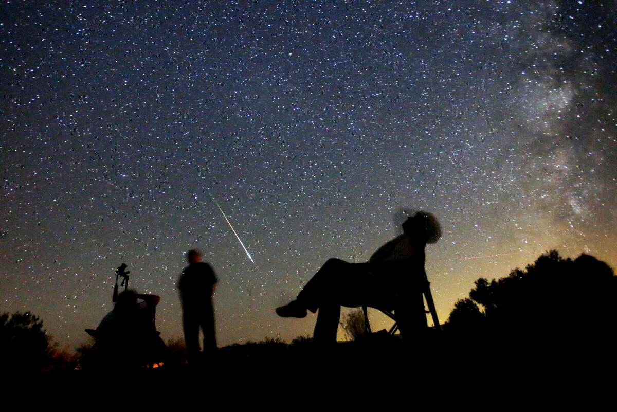 Star-gazers on a tour with California Overland Desert gaze into the starry sky above Anza-Borrego Desert State Park, CA