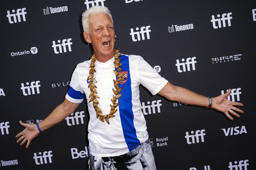 Thomas Rongen exclaims and spreads his arms during the premiere of "Next Goal Wins," at the Princess of Wales Theatre
