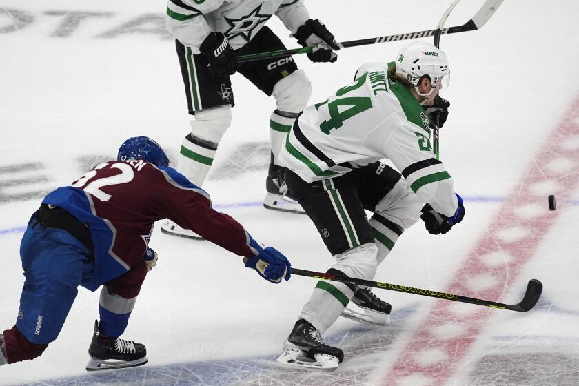 Dallas Stars center Roope Hintz, right, pursues the puck as Colorado Avalanche left wing Artturi Lehkonen defends during the third period of Game 3 of an NHL hockey Stanley Cup playoff series Saturday, May 11, 2024, in Denver. (AP Photo/David Zalubowski)