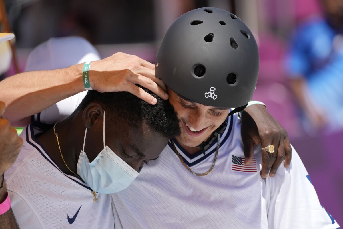 U.S. skateboarder Cory Juneau is greeted by Zion Wright during the men's park skateboarding finals.