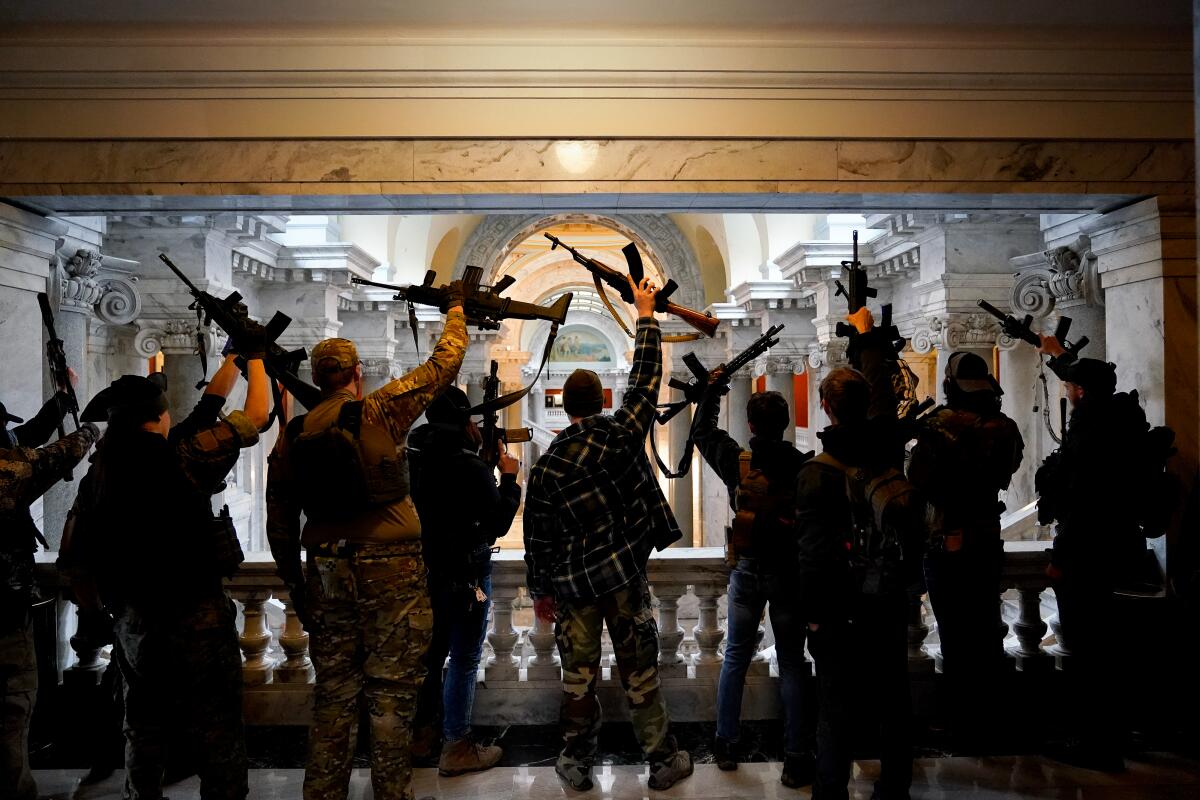 Gun-rights activists carrying semiautomatic firearms rally at the Capitol in Frankfort, Ky., in 2020.