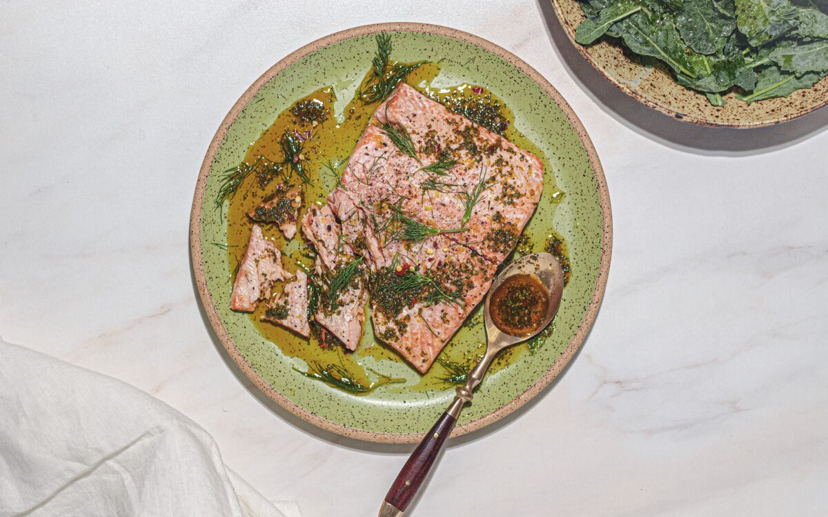 Spicy, herbal chermoula sauce adds zing to simple roast salmon and a lemony kale salad.