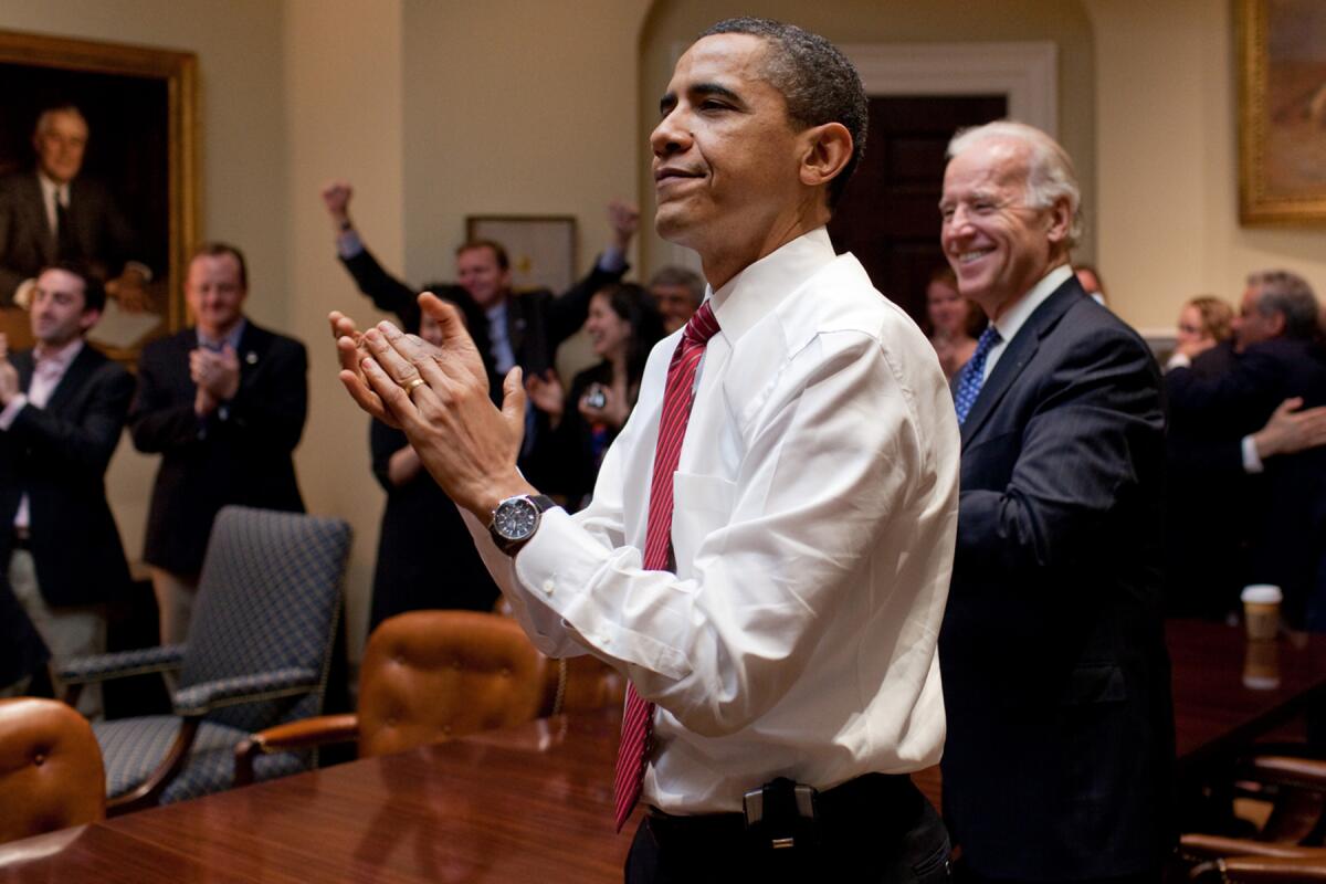 President Barack Obama, left, and Vice President Joe Biden in the White House applaud the passage of a bill. 
