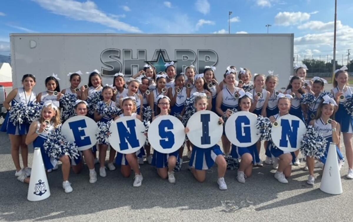 Cheerleaders from Ensign Middle School pose for a picture.