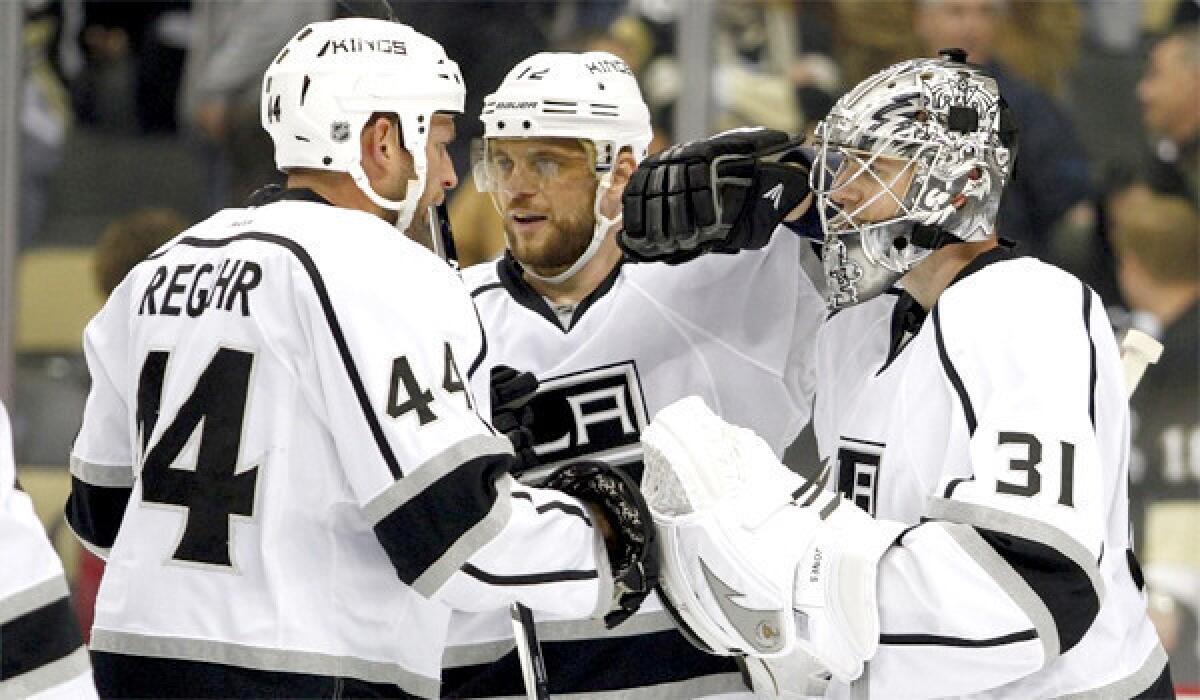 Kings goalie Martin Jones, right, celebrates L.A.'s 3-2 victory over the Pittsburgh Penguins at Consol Energy Center on Thursday with defenseman Robyn Regehr, left, and forward Marian Gaborik, right.