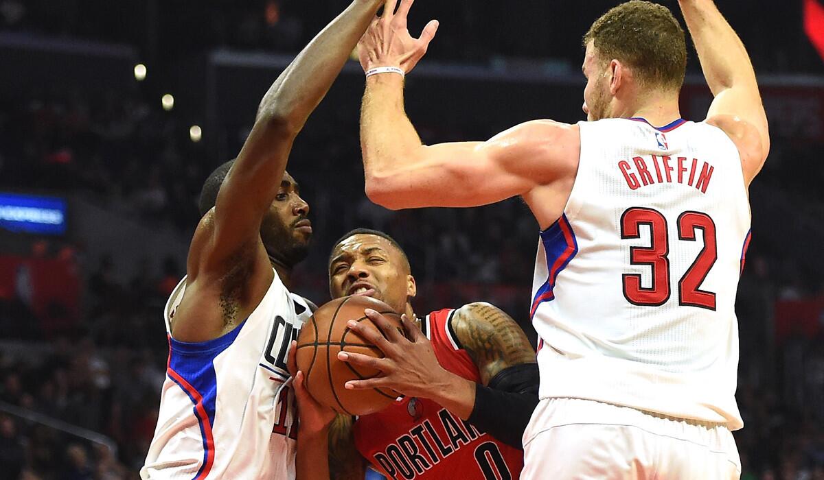 The Clippers' Chris Paul, left, and Blake Griffin cover Portland's Damian Lillard on Nov. 9.