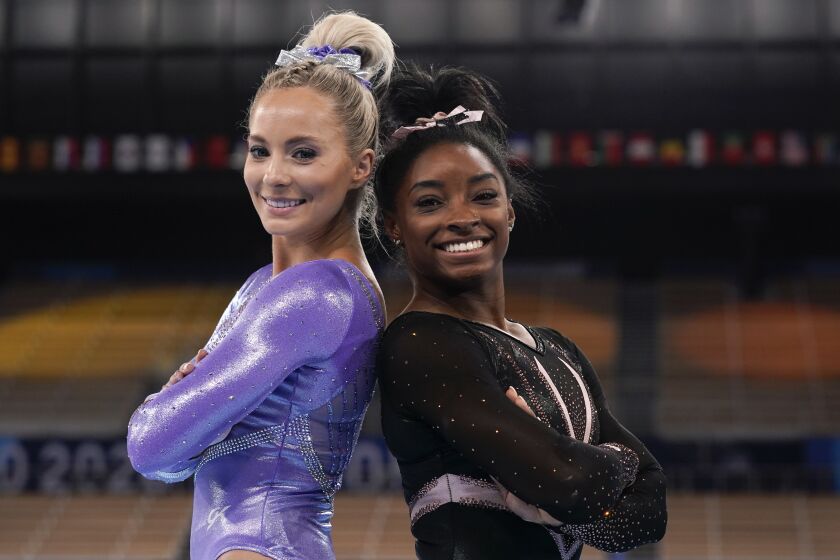 Simone Biles, of the United States, right, poses for pictures with teammate MyKayla Skinner.