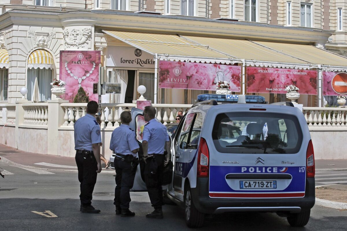Police outside the Carlton hotel in Cannes, France, which has been the scene of jewel heists both theatrical and all too real.