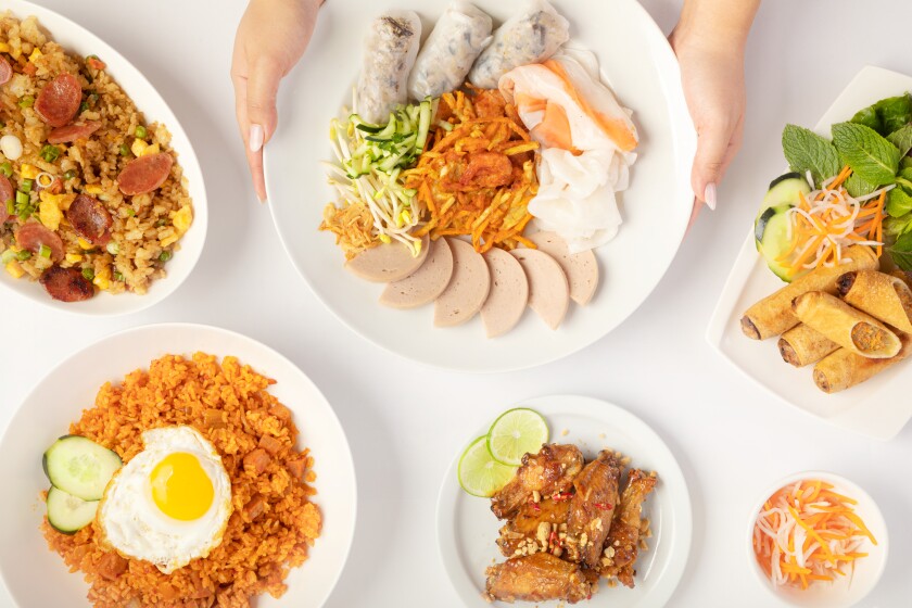 An overhead photo of Tay Ho's Vietnamese dishes including banh cuon, fried rice and crispy spring rolls.