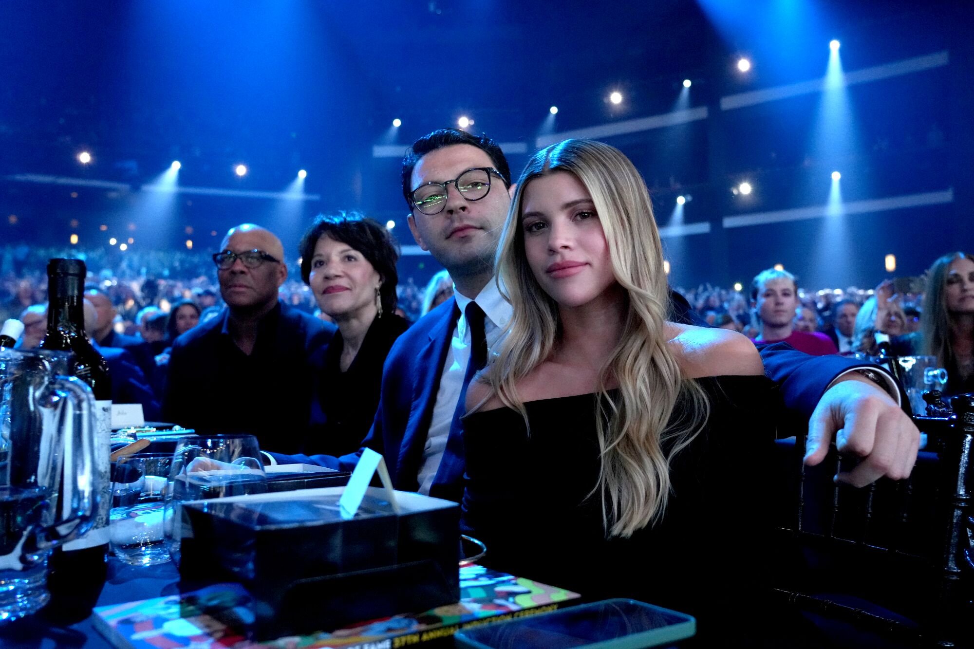 A row of people seated at an awards dinner.