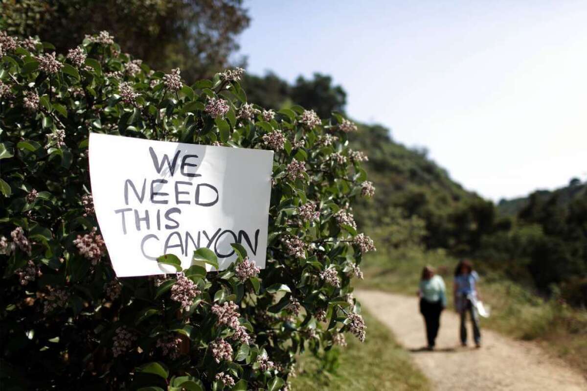 Signs of discontent were posted along Hastain trail in L.A.'s Franklin Canyon Park in April 2011, to protest proposed real estate development by Mohamed Hadid, whose property includes parts of the trail.