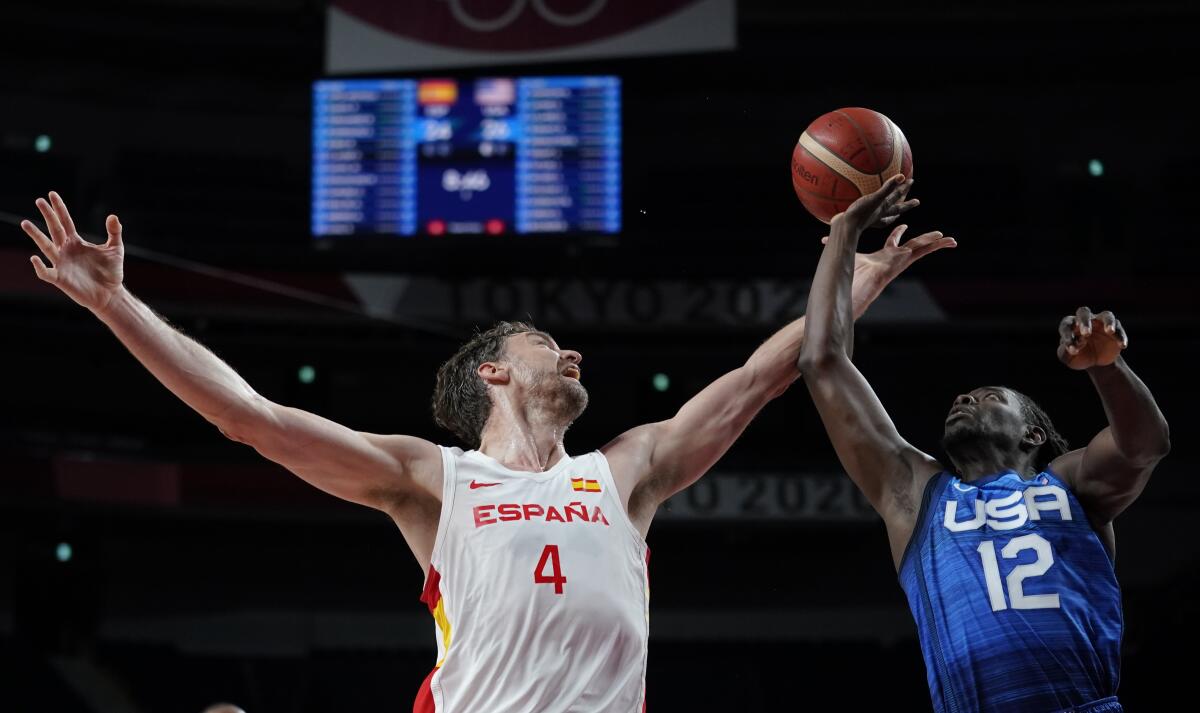 Spain's Pau Gasol, left, and Jrue Holiday of the U.S. fight for a rebound during Tuesday's game.