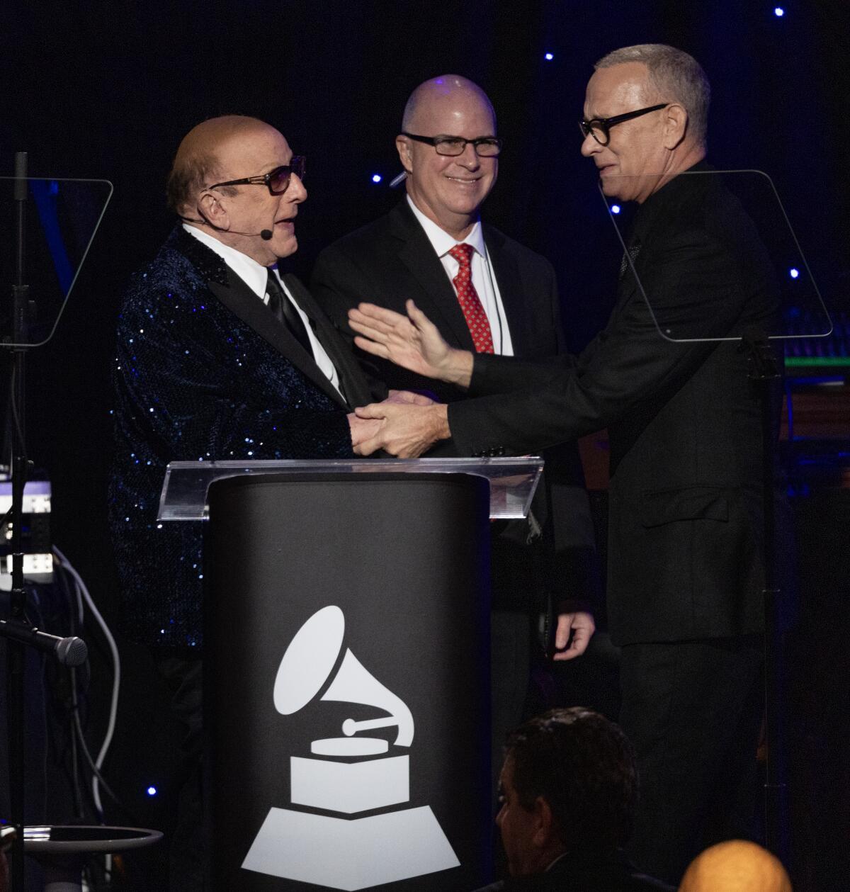 Tom Hanks introduces Clive Davis during the 66th Grammy Awards Pre-Grammy Gala.