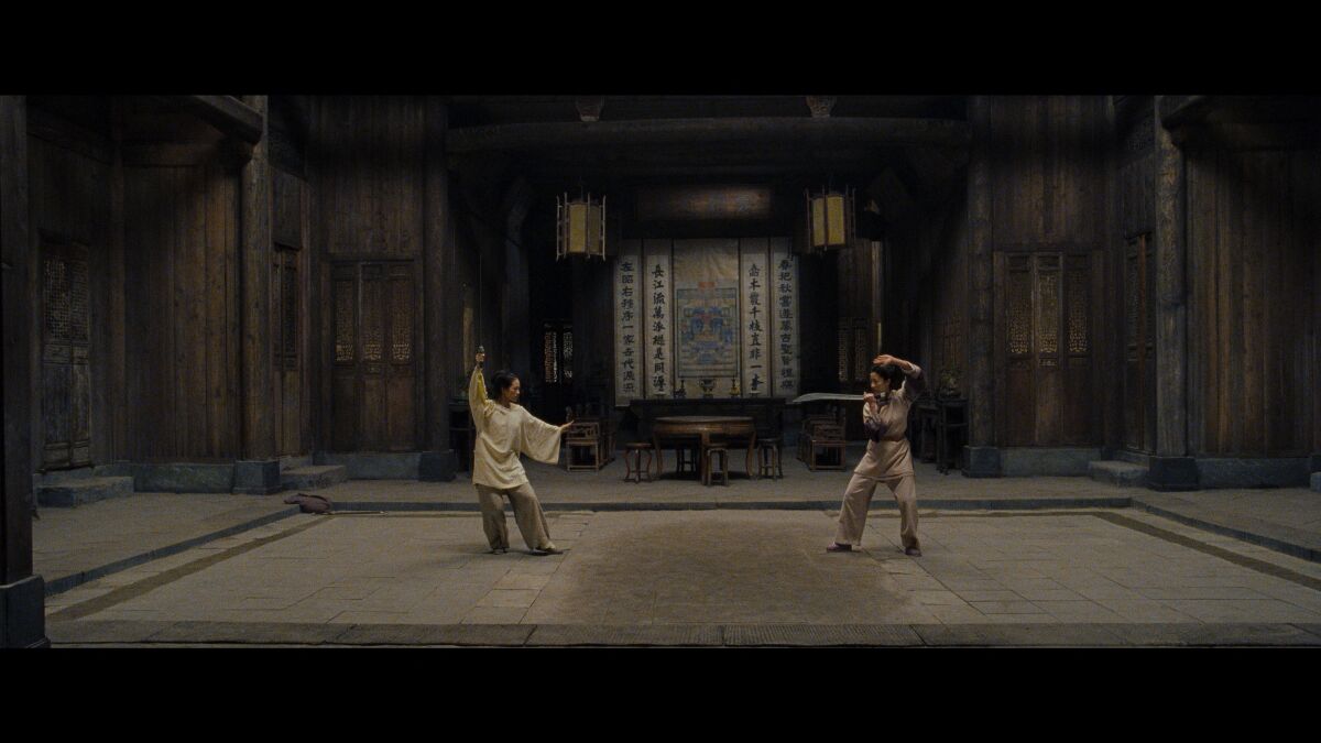 Two women prepare to do battle in the movie "Crouching Tiger, Hidden Dragon."