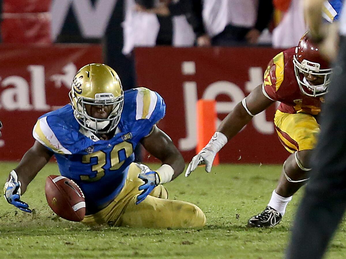 UCLA linebacker Myles Jack recovers a fumble by USC running back Javorius Allen in last season's rivalry game. If turnovers don't help decide this season's contest, penalties just might.
