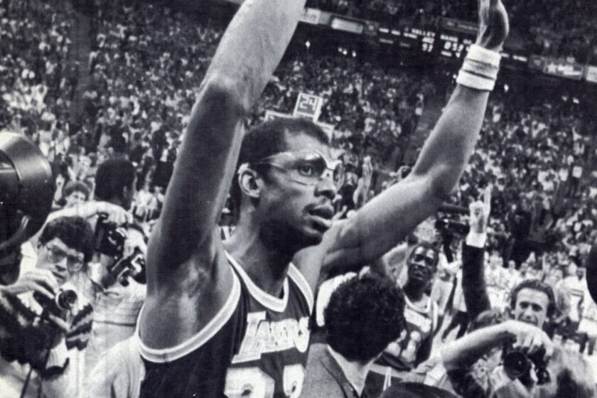 Kareem Abdul-Jabbar rejoices after passing Wilt Chamberlain in 1984 for the most points in a career with 31,149.
