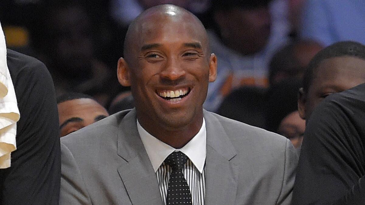 Lakers star Kobe Bryant laughs while sitting on the bench during a game against the Minnesota Timberwolves on April 10.