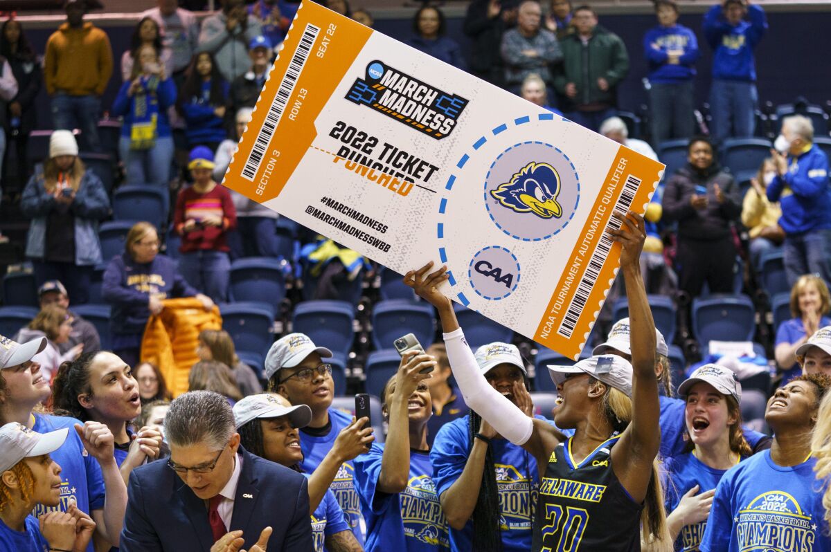 FILE - Delaware's Jasmine Dickey holds up the March Madness ticket following the second half of an NCAA college basketball championship game against Drexel in the Colonial Athletic Association Conference Tournament, Sunday, March 13, 2022, in Philadelphia. Delaware won 63-59. The NCAA has adequately addressed nine of 23 recommendations for creating comparable NCAA Tournament experiences for men's and women's basketball players, according to a progress report released Wednesday. July 20, 2022. (AP Photo/Chris Szagola, File)