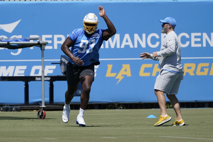 Chargers defensive lineman Otito Ogbonnia runs a drill during camp.