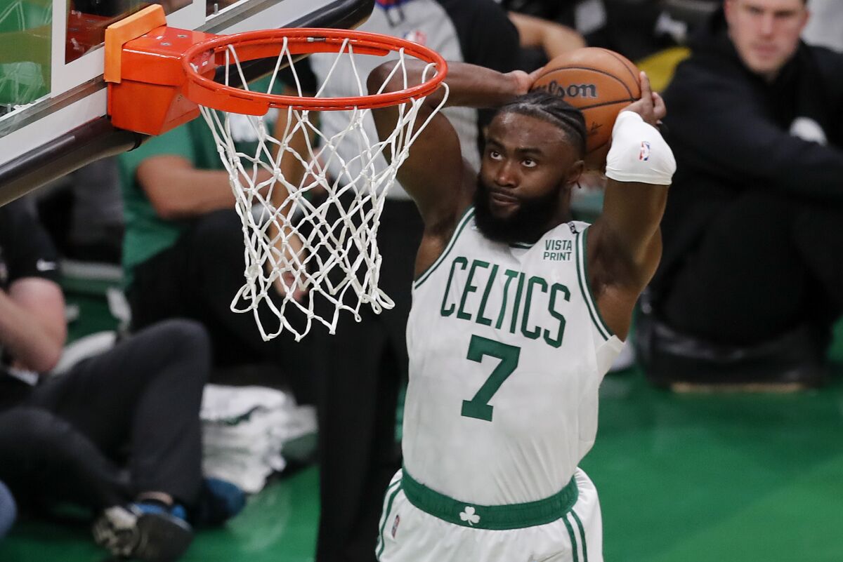 Boston Celtics guard Jaylen Brown (7) dunks the ball against the Golden State Warriors during the second quarter of Game 3 of basketball's NBA Finals, Wednesday, June 8, 2022, in Boston. (AP Photo/Michael Dwyer)