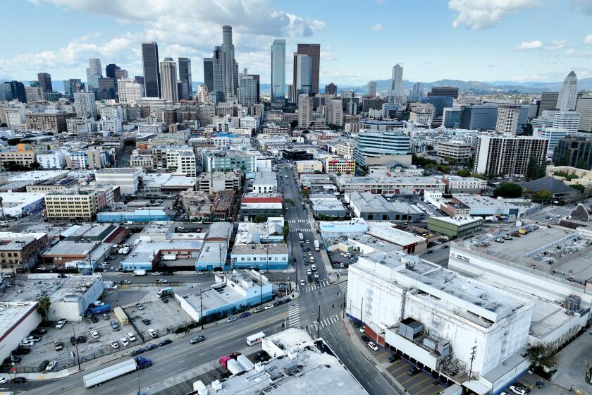 Los Angeles, CA - March 07: An aerial view of the area neighboring Central Avenue and 4th Street downtown Los Angeles where Gov. Gavin Newsom is attempting to expedite construction of a $2-billion residential and commercial megadevelopment. The 7.6-acre project, named Fourth & Central, would bring 1,500 new homes, 410,000 square feet of office space along with retail, restaurants and a 68-room hotel to what's now a collection of cold storage facilities, parking lots and warehouses in Skid Row near its boundary with the Arts District. Photo taken in in Los Angeles Thursday, March 7, 2024. (Allen J. Schaben / Los Angeles Times)