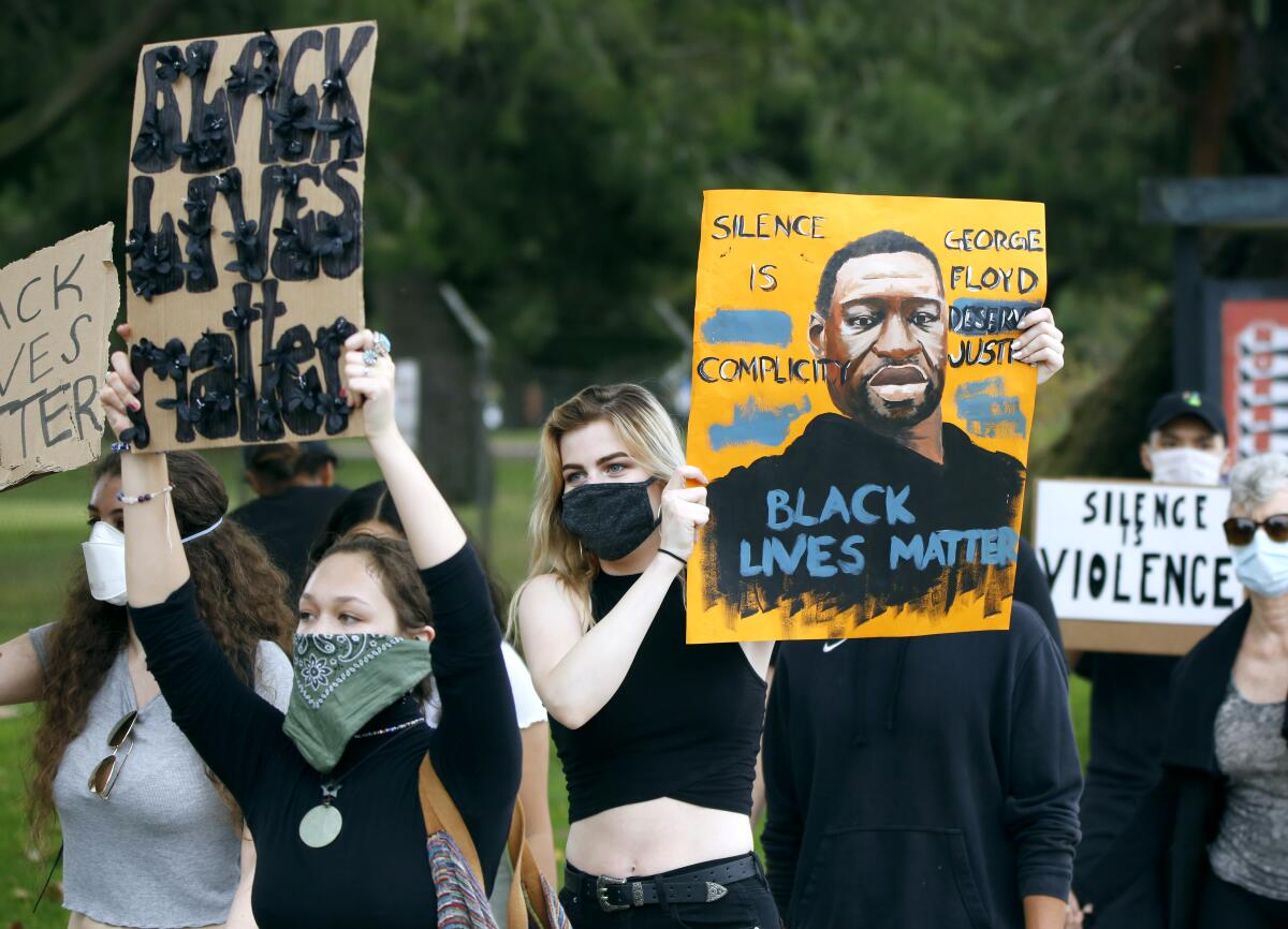 Hundreds like Sarah Dilitkanich, center, marched around Mile Square Regional Park in support of George Floyd on Thursday.