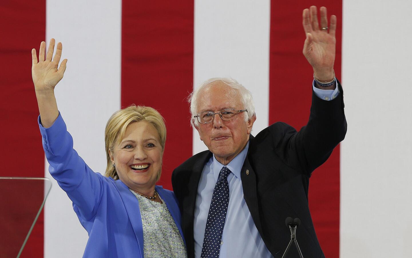 Democratic Presidential candidate Hillary Clinton with former Democratic Presidential candidate Bernie Sanders as they appear together at an event in Portsmouth, New Hampshire.