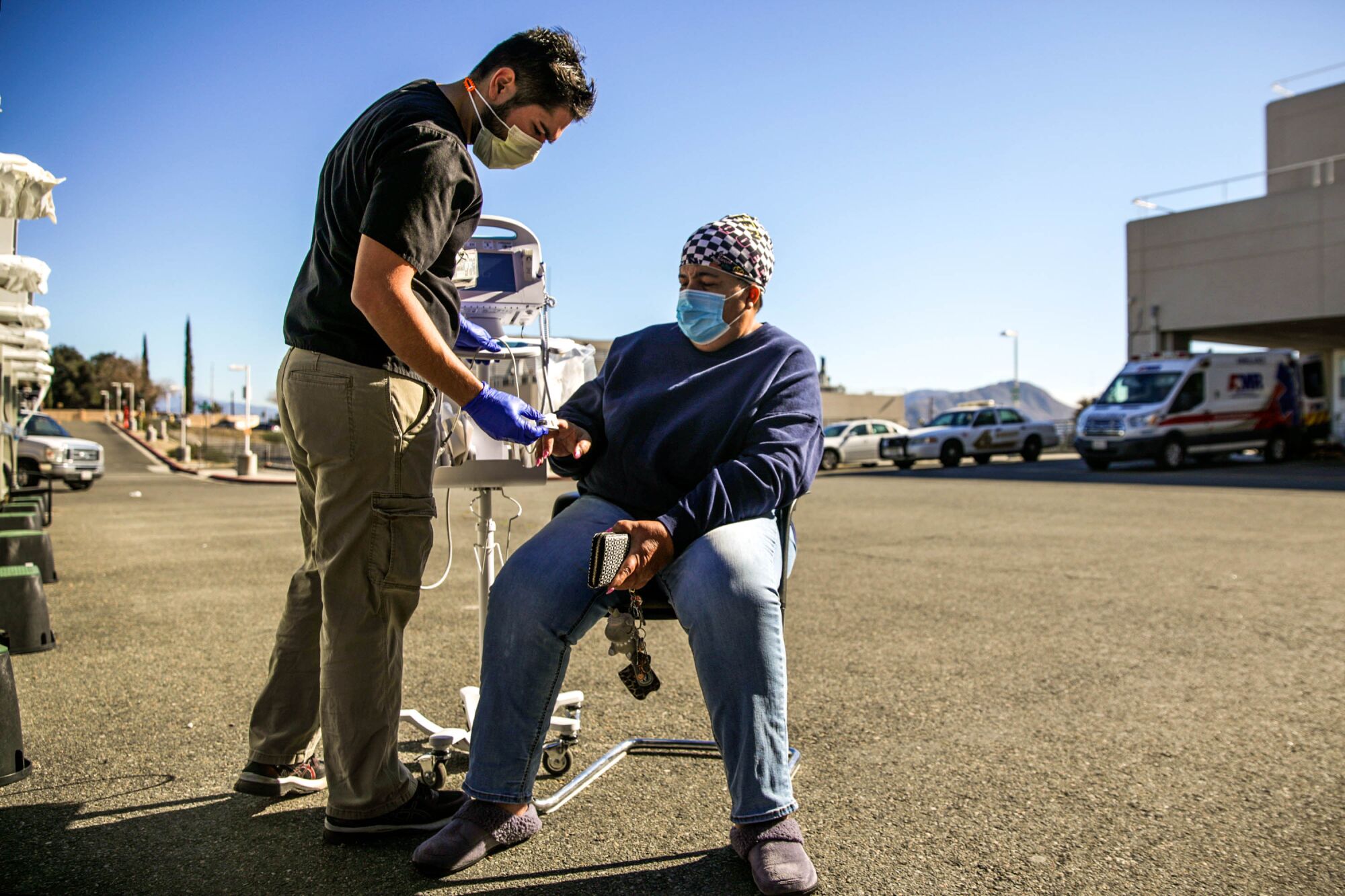 Nurse Rafael Sanchez evaluates a COVID-19 patient.