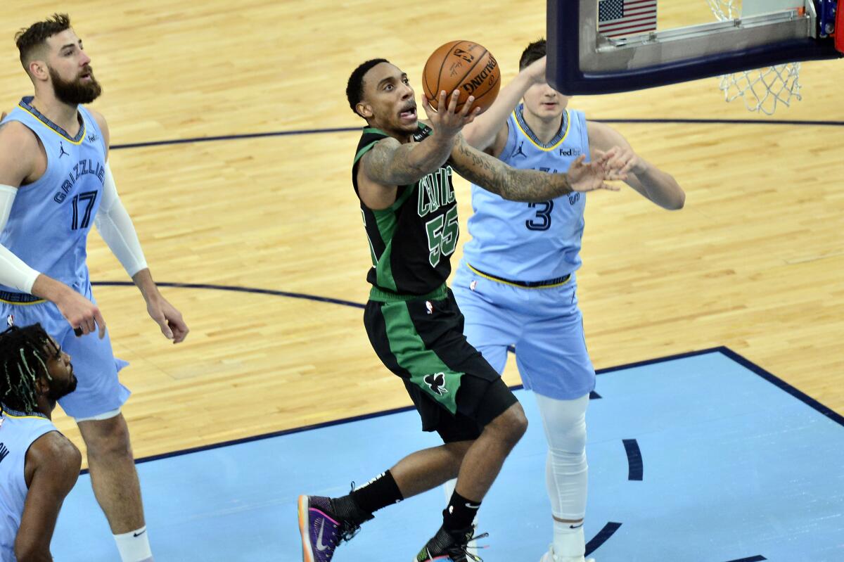 Boston Celtics guard Jeff Teague (55) shoots against Memphis Grizzlies guard Grayson Allen (3) in the first half of an NBA basketball game Monday, March 22, 2021, in Memphis, Tenn. (AP Photo/Brandon Dill)