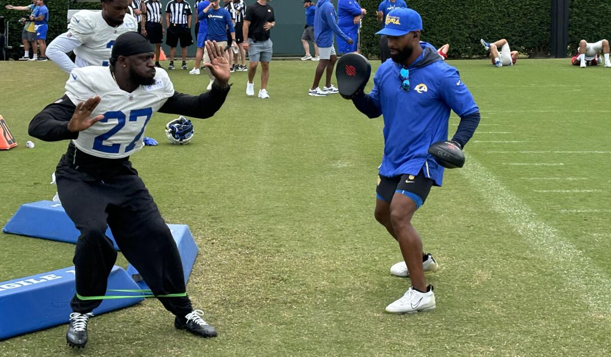 Rams cornerback Tre’Davious White works with defensive backs coach Aubrey Pleasant.