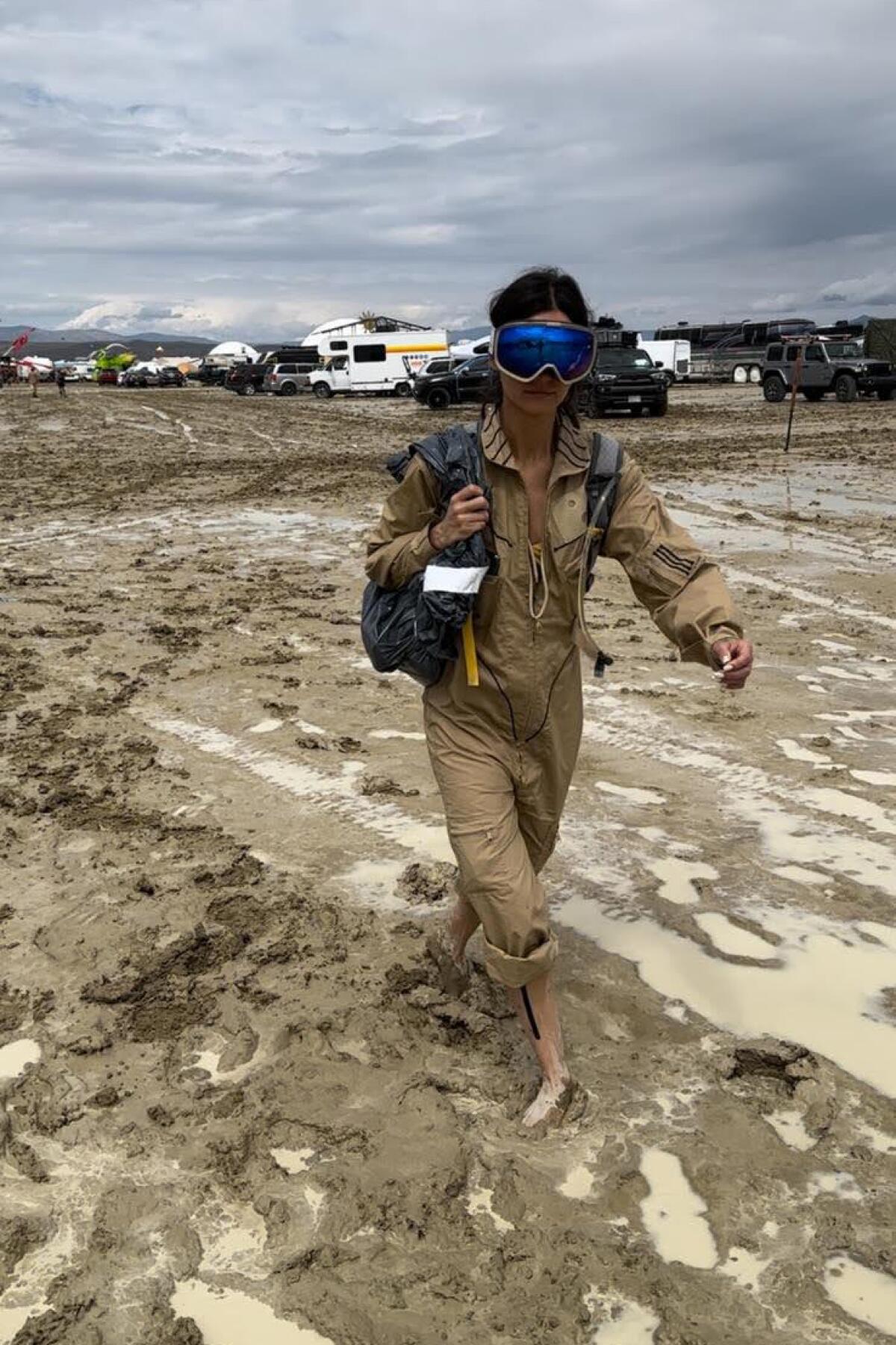 A person walks in mud.