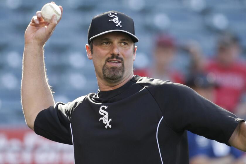 Chicago White Sox first baseman Paul Konerko throws a ball before Friday's game against the Angels. Konerko has come a long way since making his major league debut with the Dodgers in 1997.