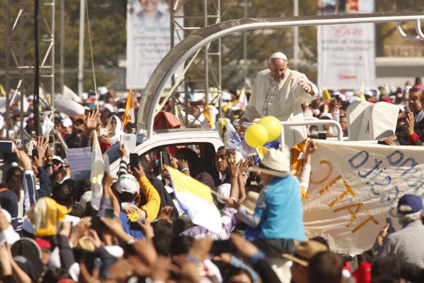 SAN CRISTOBAL DE LAS CASAS, MEXICO - FEBRUARY 15, 2016 - Pope Francis waves to pilgrims as he rides through the crowd of pilgrims at the Municipal Sports Center in San Cristobal de las Casas, Mexico, on February 15, 2016.(Genaro Molina / Los Angeles Times)