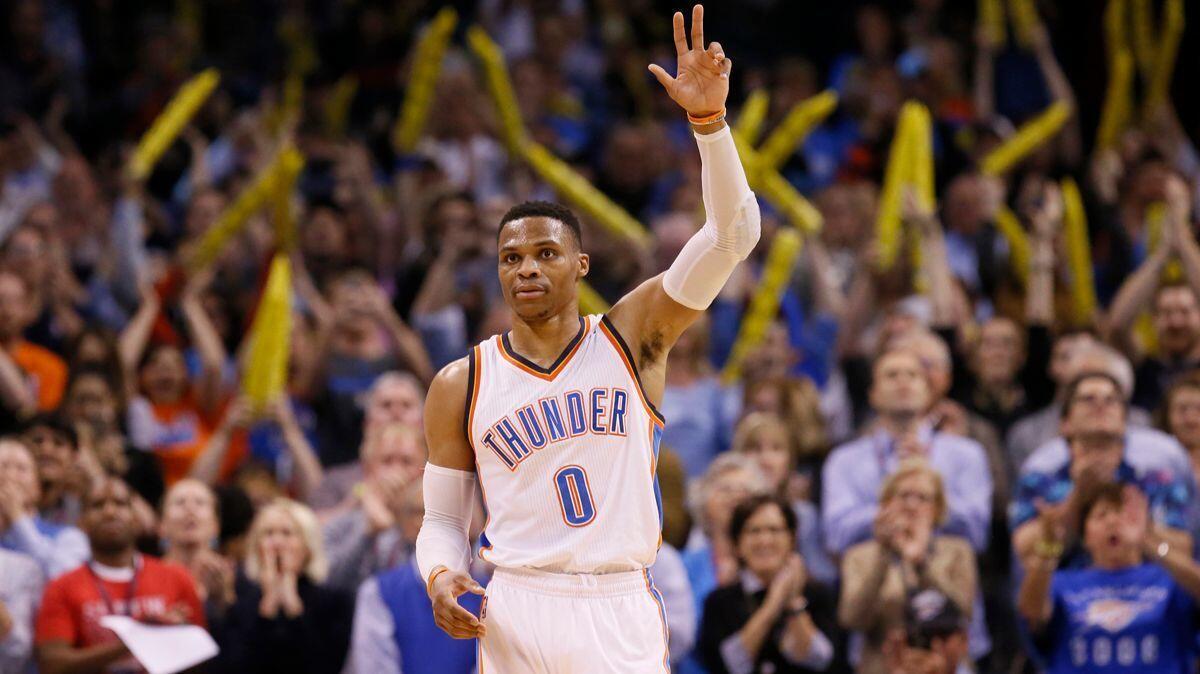 Oklahoma City Thunder guard Russell Westbrook waves to the crowd after tying the record for triple-doubles in a season in the third quarter against the Milwaukee Bucks on Tuesday.