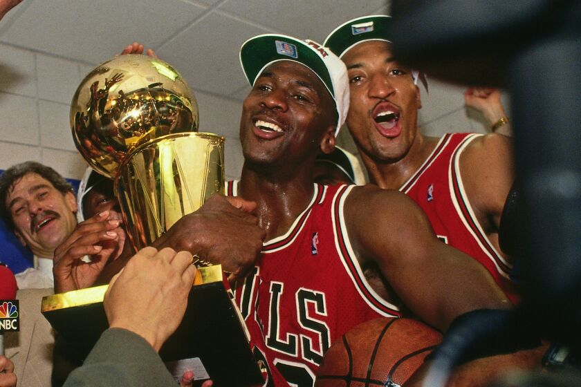 A photographed featured in "The Last Dance." PHOENIX - JUNE 20: NBA Commissioner David Stern presents Michael Jordan and the Chicago Bulls the championship trophy after the Bulls defeated the Phoenix Suns in Game Six of the 1993 NBA Finals on June 20, 1993 at America West Arena in Phoenix, Arizona. NOTE TO USER: User expressly acknowledges and agrees that, by downloading and or using this photograph, User is consenting to the terms and conditions of the Getty Images License Agreement. Mandatory Copyright Notice: Copyright 1993 NBAE (Photo by Andrew D. Bernstein/NBAE via Getty Images)