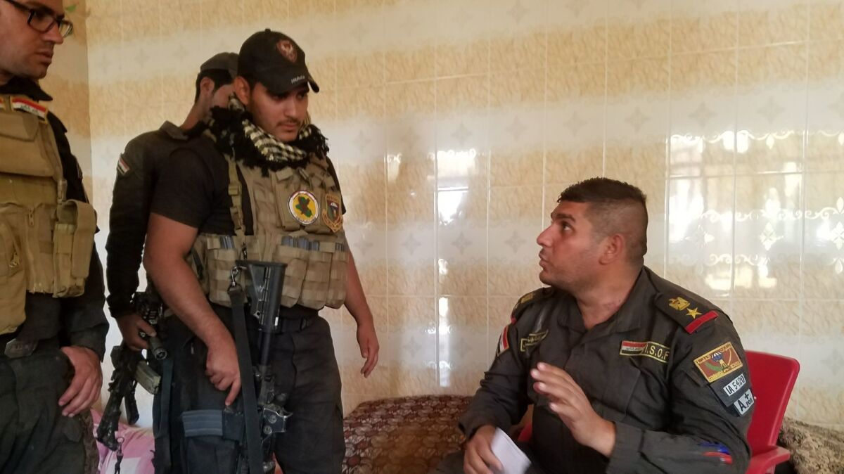 Lt. Col. Ali Hussein Fadil, right, directs some of the 166 Najaf-based special forces soldiers under his command, including Saud Messoud Jamal, 31, left, whose Mosul-area village the offensive has freed from Islamic State.