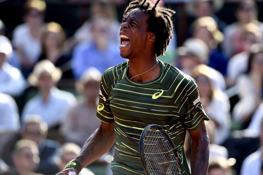 Gael Monfils reacts after winning a point against Diego Schwartzman during their second-round match at the French Open on Wednesday in Paris.