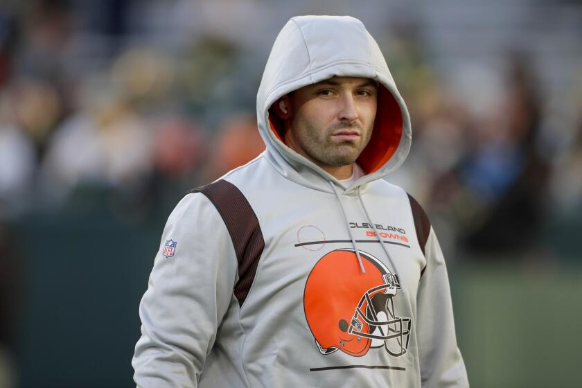 Cleveland Browns' quarterback Baker Mayfield wears his hood up on his Browns sweatshirt before a game against Green Bay.