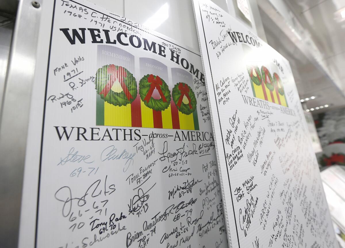 Signatures from Vietnam veterans can be seen on posters.