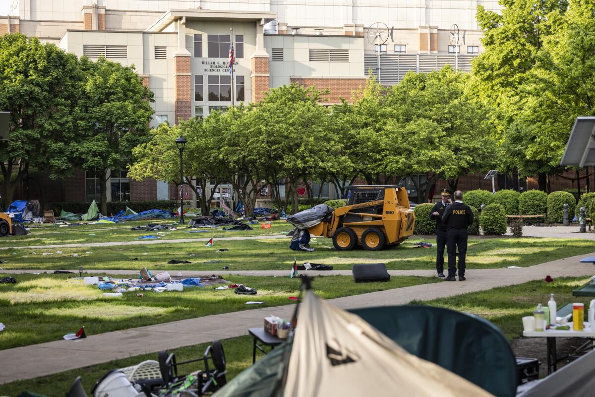 Chicago police keep watch while crews disassemble pro-Palestinian encampment at DePaul University.