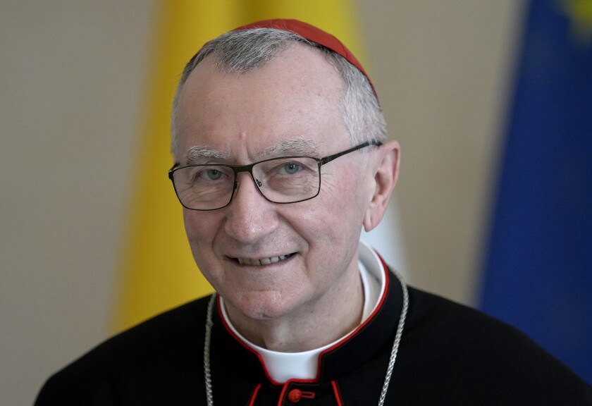 FILE - Vatican Secretary of State Cardinal Pietro Parolin smiles as he is welcomed by German President Frank-Walter Steinmeier for a meeting at the Bellevue palace in Berlin, Germany on June 29, 2021. The European Commission on Tuesday Nov. 30, 2021, retracted internal communication guidelines that had proposed substituting the “Christmas period” with “holiday period” after an outcry by conservatives and the Vatican, which termed the document an attempt to “cancel” Europe’s Christian roots. Even the Vatican secretary of state, Cardinal Pietro Parolin, intervened with an unusually sharp critique. (AP Photo/Michael Sohn, File)