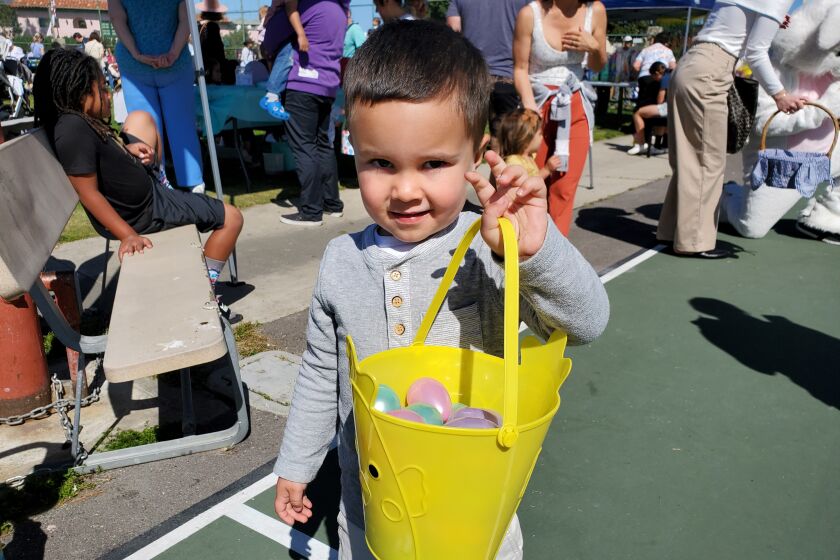 Jack , 3, (last name withheld) shows off his loot at the Hippity Hop Egg-stravaganza at the La Jolla Recreation Center.