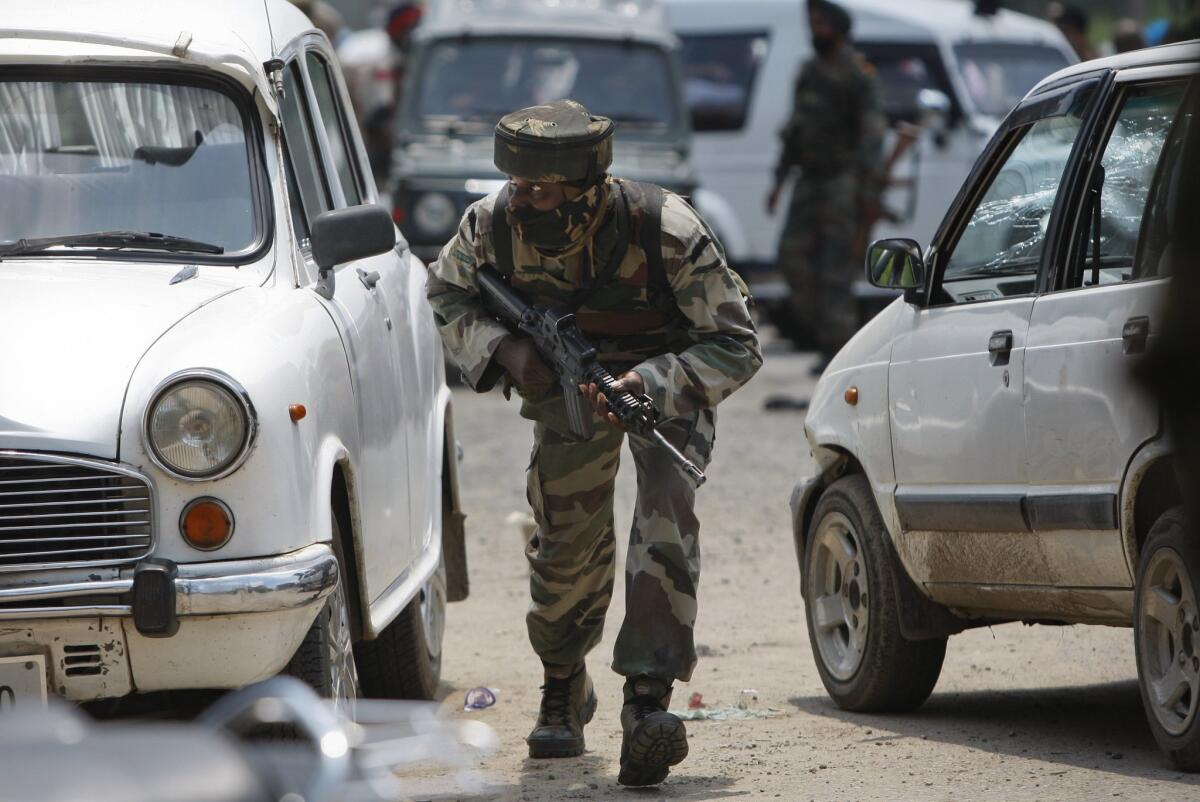 An Indian army soldier takes position during a fight with militants in the town of Dinanagar on July 27.
